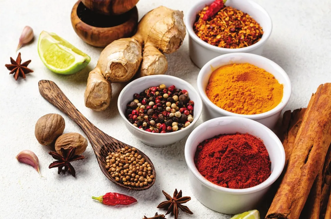 Whole and ground spices: turmeric, chilli, peppercorns, ginger and cinnamon